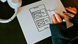 drawing out plan for web design layout on peice of paper