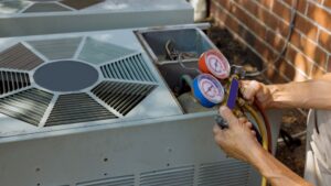 Person holding HVAC tool to check gauges and machines for issues