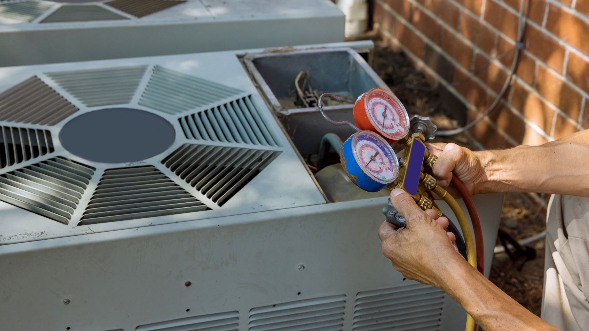 Person holding HVAC tool to check gauges and machines for issues